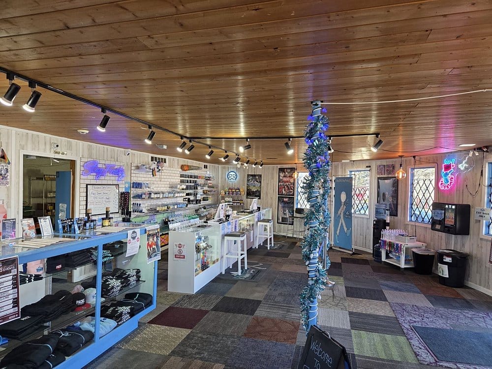 Frosteez Cannabis Dispensary Interior, Montana Inside a Frosteez Cannabis dispensary in Montana with lit display cases packed with products and neon signs